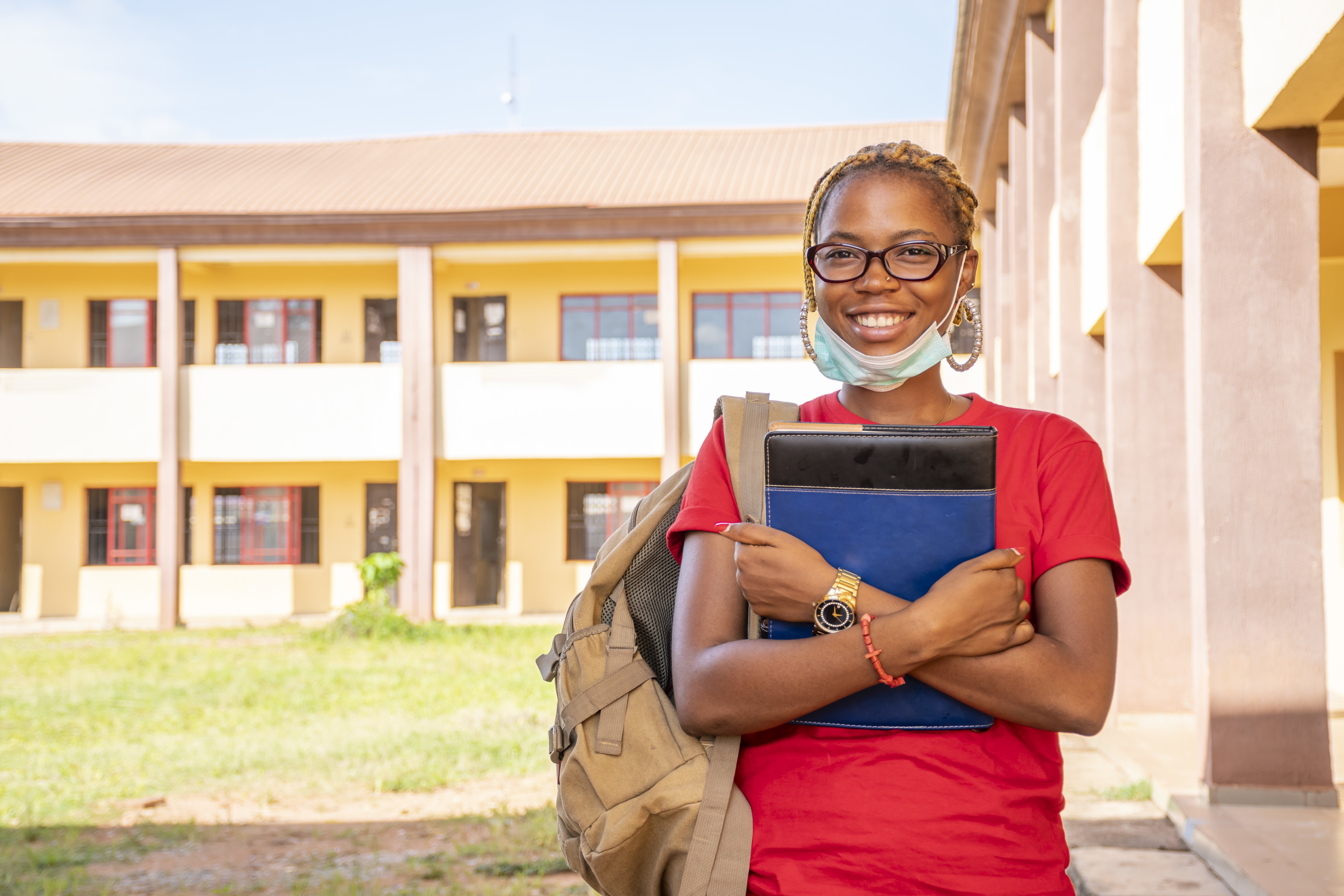 Young African Female Student With Facemask Holding Her Textbooks Campus Area 1