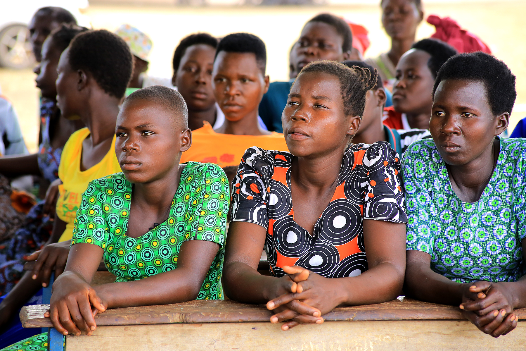 Girls listening during a community learning session